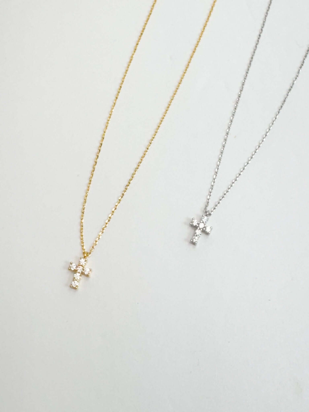 small rhinestone cross pendant on delicate chain in either gold or silver