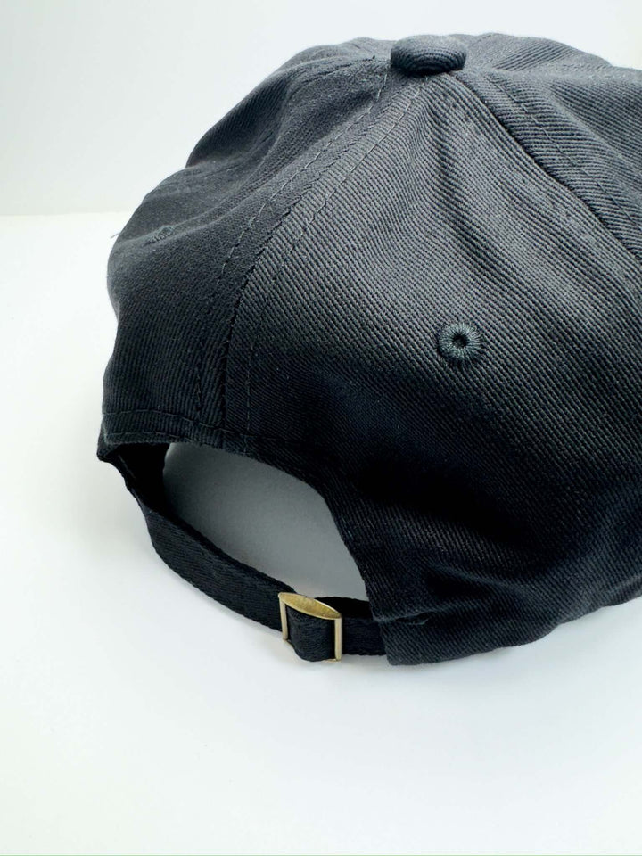 A black baseball cap with the text 'Game Day' embroidered in orange on the front.