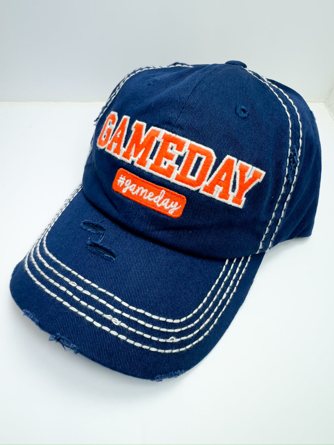 A blue and orange striped baseball cap with 'Game Day' text in orange on the front.