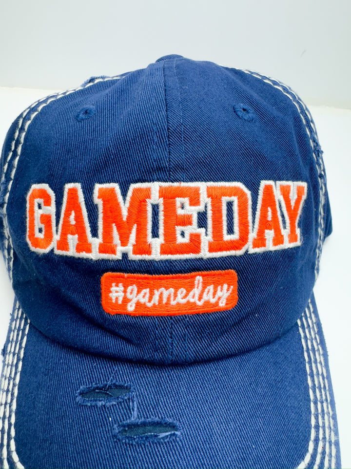 A blue and orange striped baseball cap with 'Game Day' text in orange on the front. 2