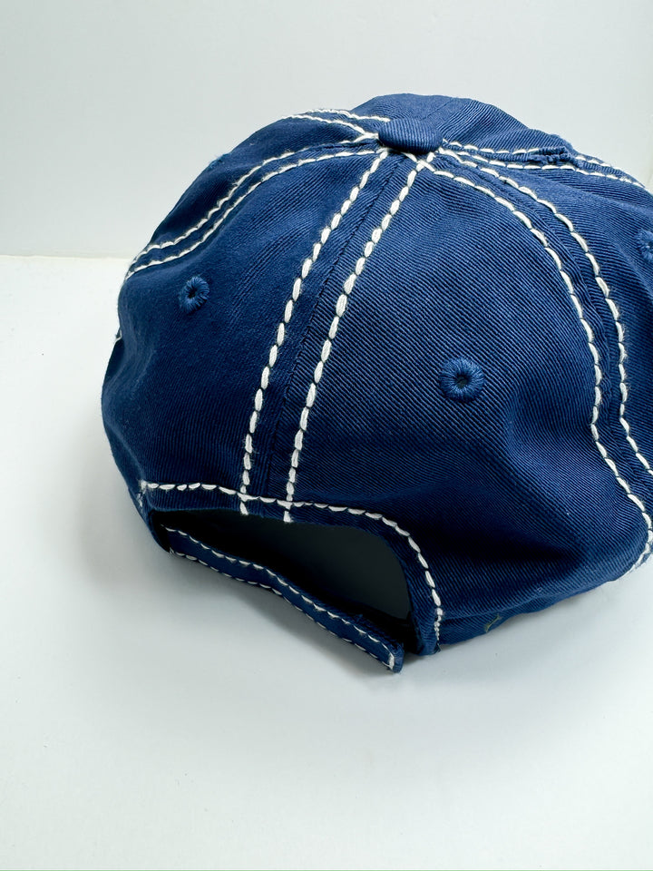 A blue and orange striped baseball cap with 'Game Day' text in orange on the front.