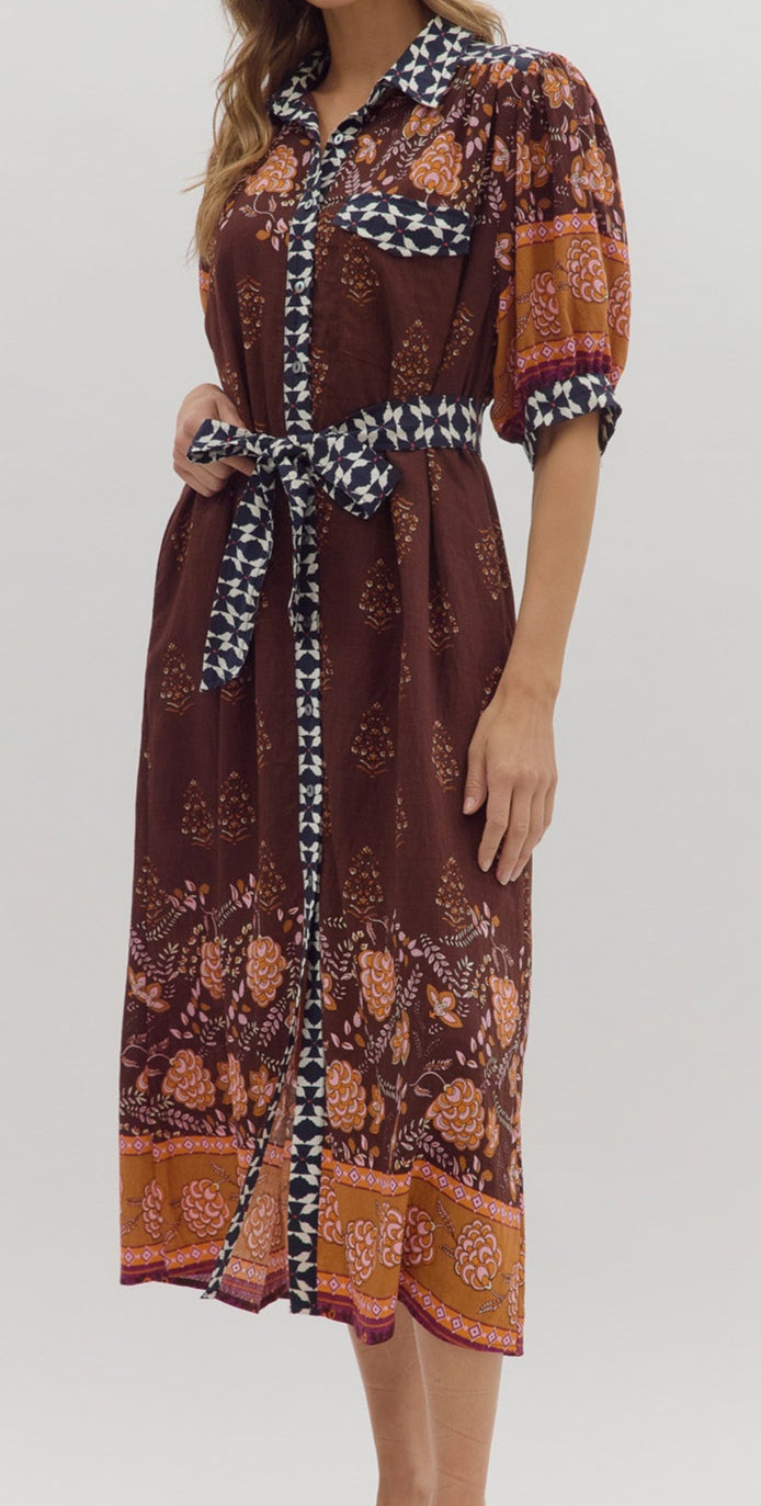 Woman wearing a patterned dress on a white background