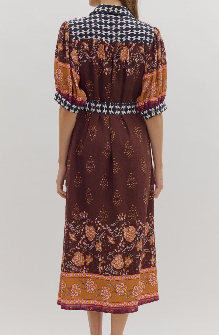 Woman wearing a patterned dress with a white background