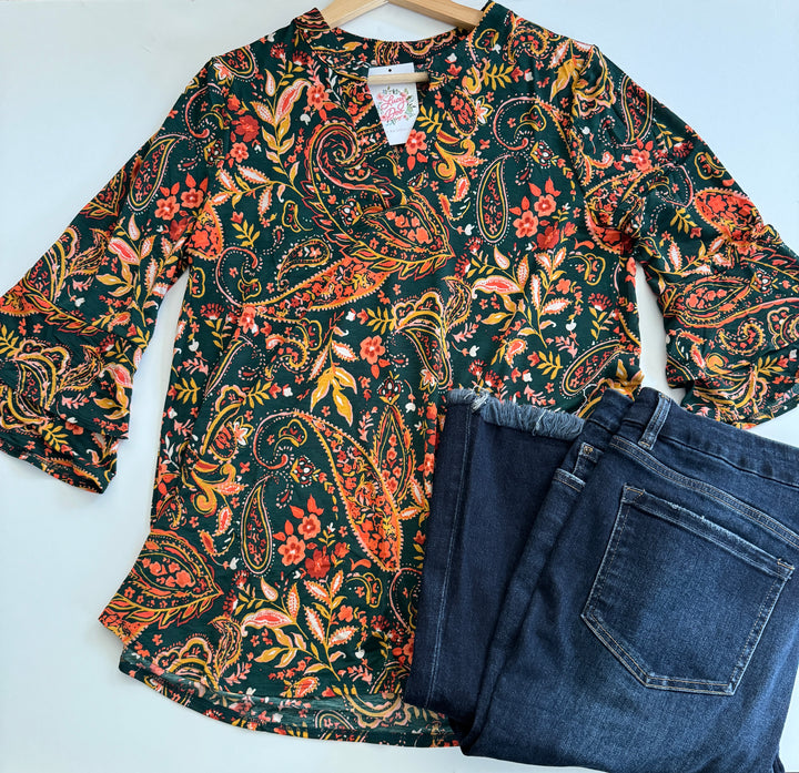Floral paisley blouse and blue jeans on a white background