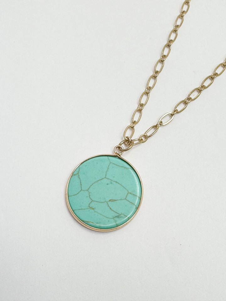 photo of gold link necklace with circular marbled turquoise pendant