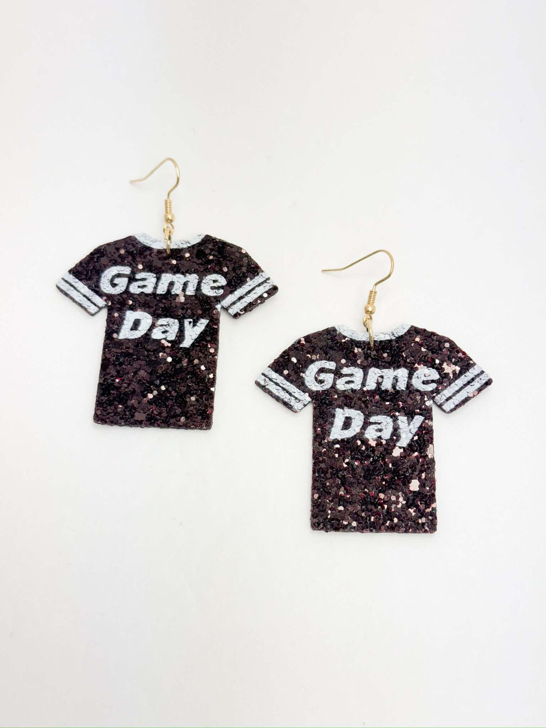 A pair of maroon and white game day earrings with sequins, designed to be lightweight.