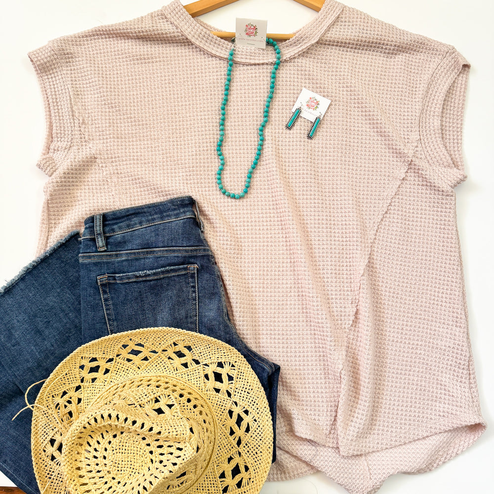 flat lay of oatmeal colored waffle knit top