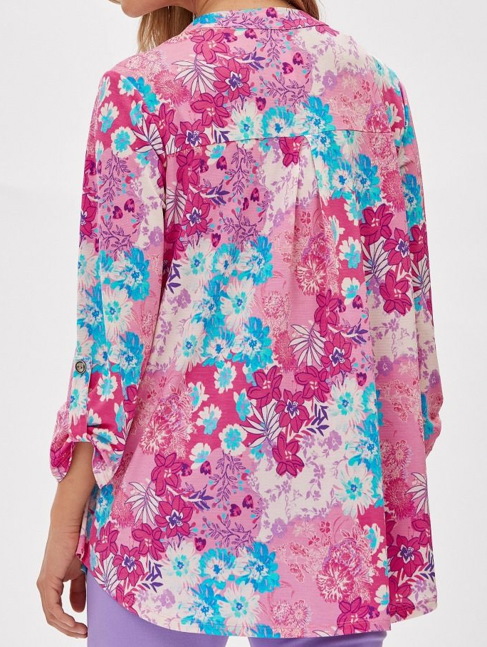 Floral patterned shirt with pink, blue, and white colors on a plain background