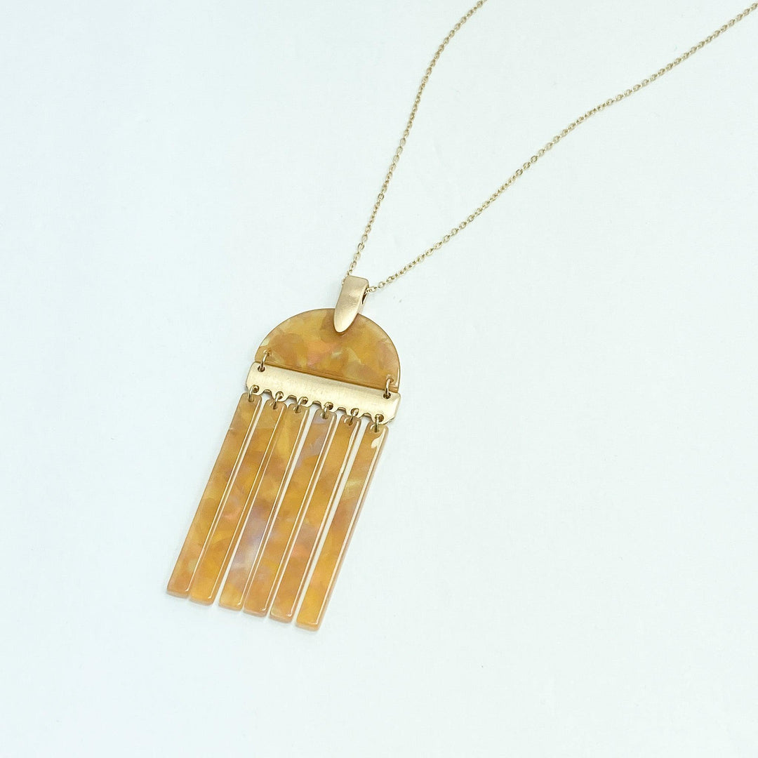 Long Necklace w/ Tan Acrylic Tassel Pendant on white background