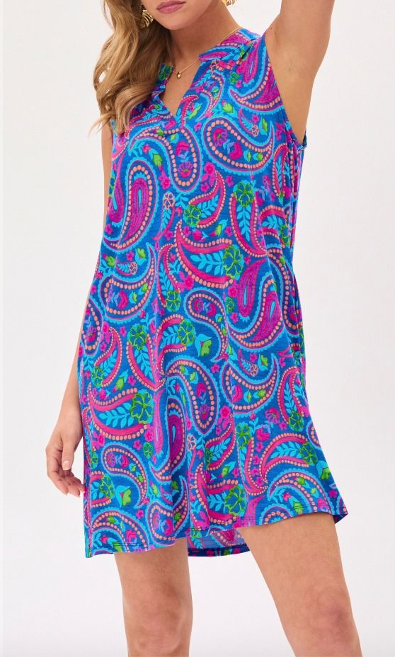 Woman wearing a colorful paisley dress on a white background