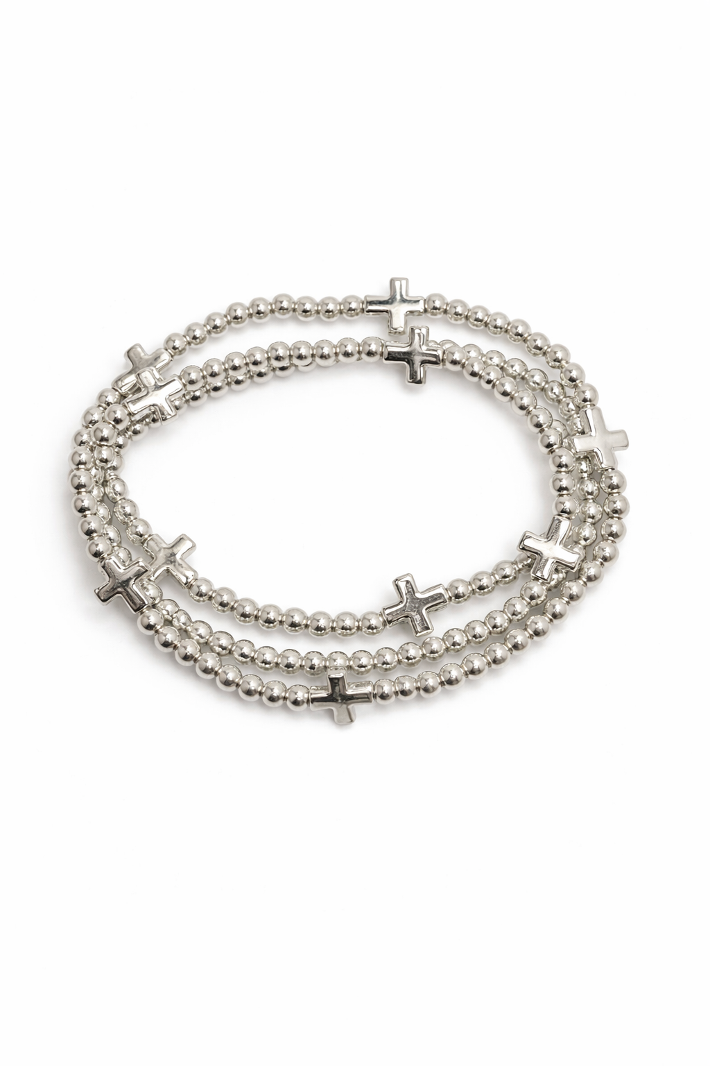 Stack of silver beaded bracelets with cross charms on a white background