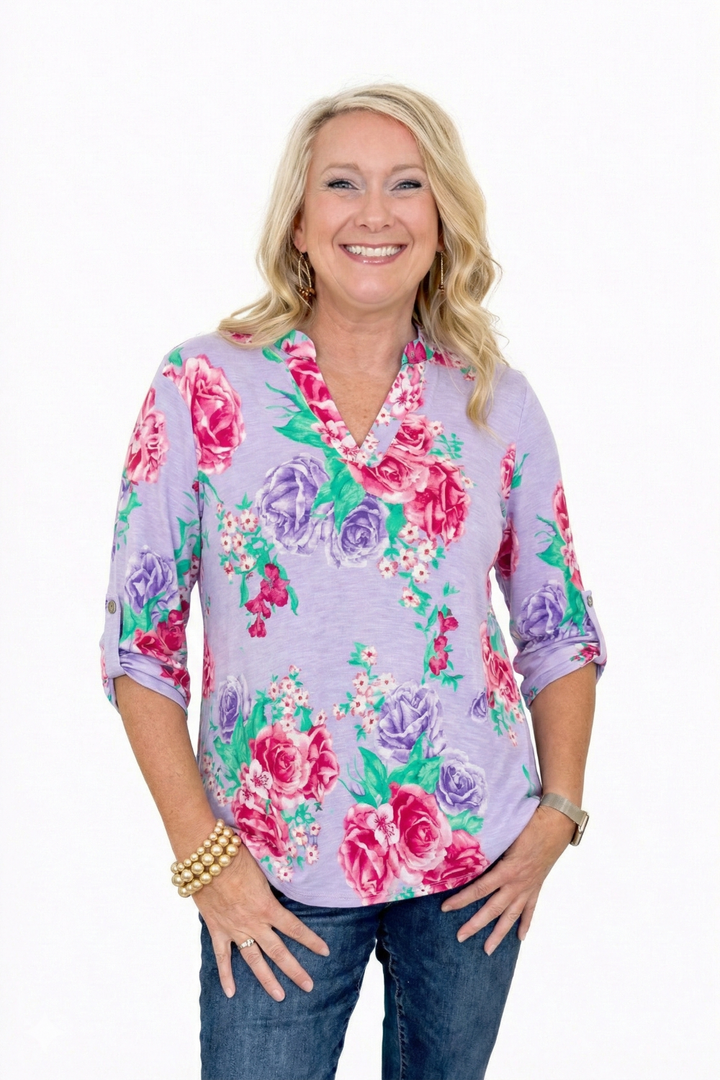 model wearing lavender floral top on white background