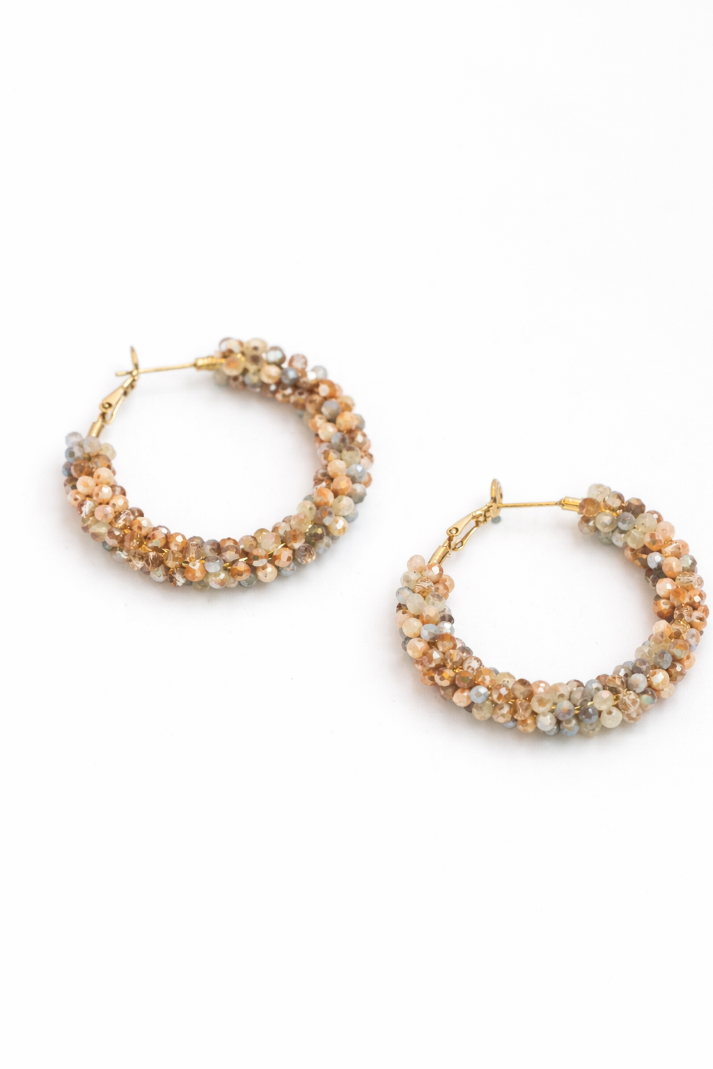 Pair of beaded hoop earrings on a white background