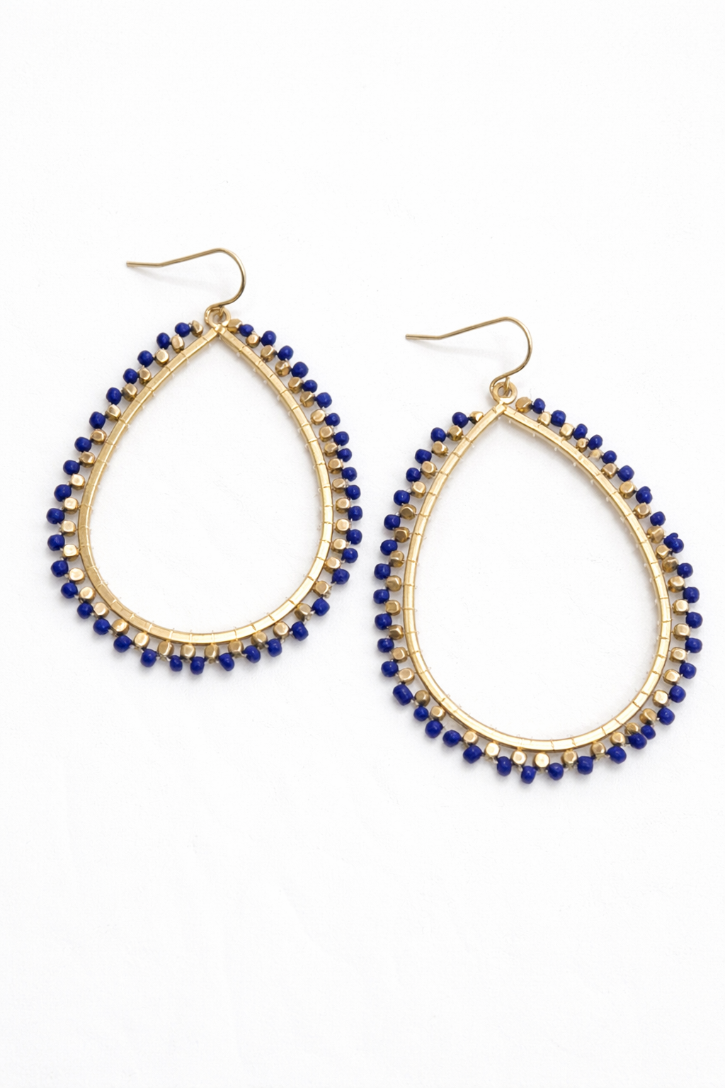 Gold hoop earrings with blue beads on a white background