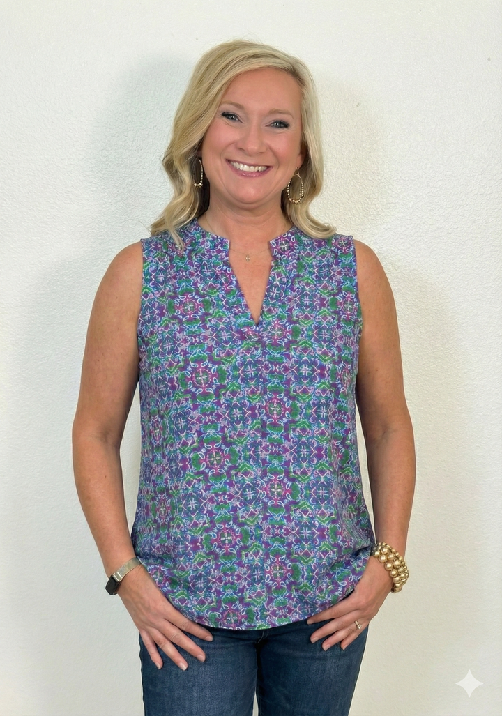 Woman wearing a sleeveless floral top against a white background