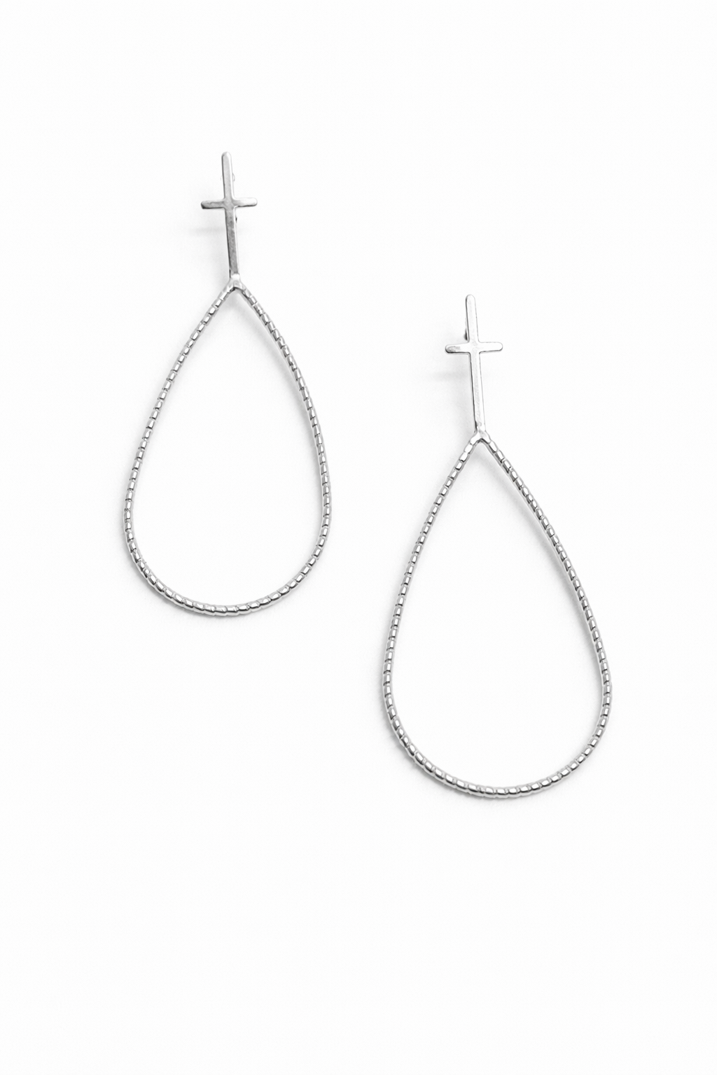 Teardrop-shaped silver earrings on a white background