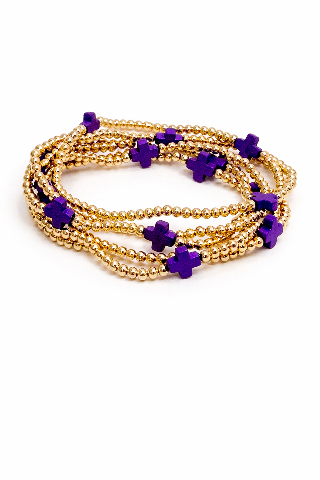 Gold beaded bracelets with purple flower-shaped beads on a white background