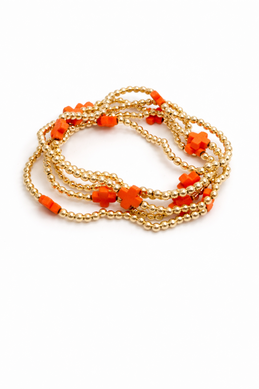Gold beaded bracelet with orange beads on a white background