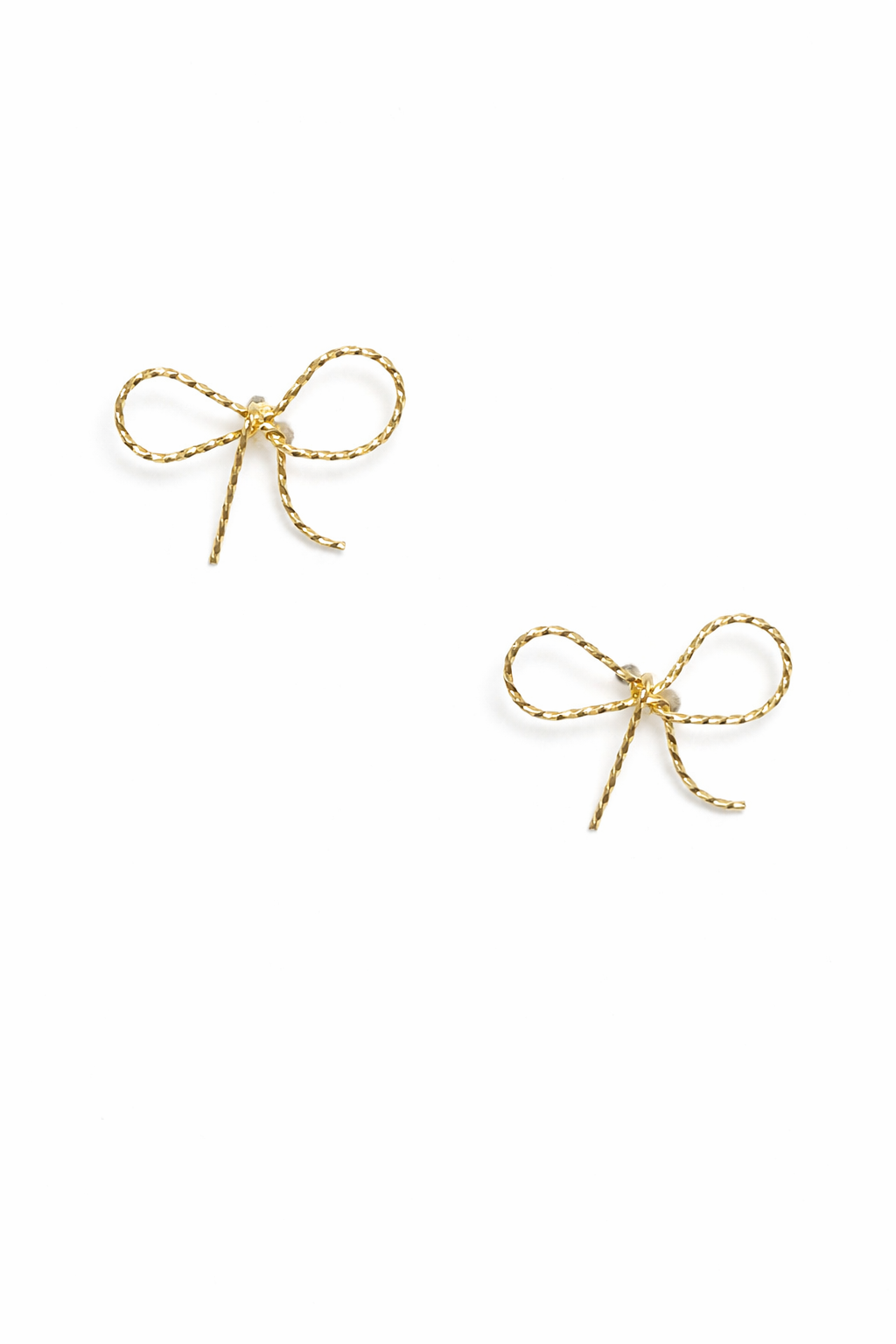 Two gold bow-shaped earrings on a white background