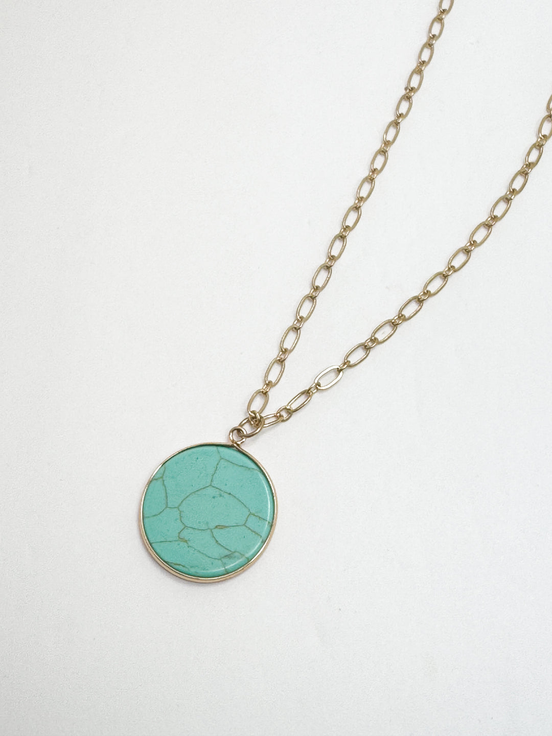 Necklace with a turquoise pendant on a white background