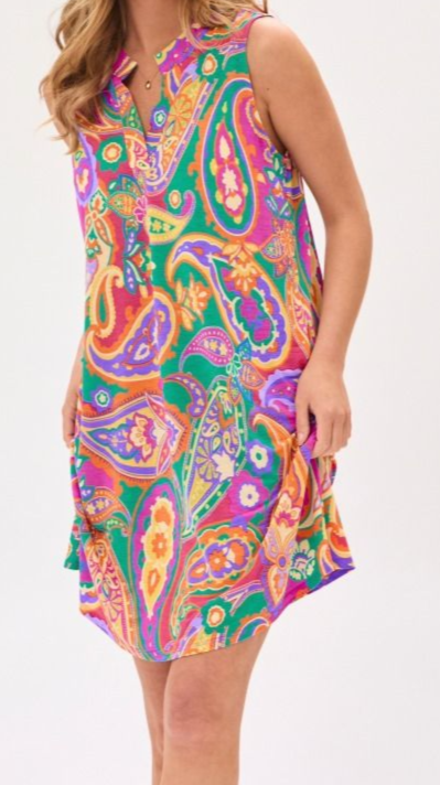 Woman wearing a colorful paisley dress on a white background