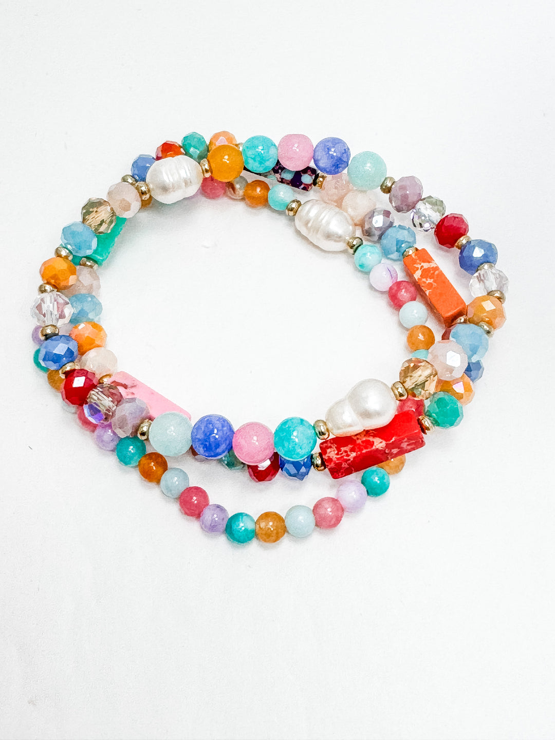 mix of bright pink, orange, purple, pearl beads on a stretchable bracelet