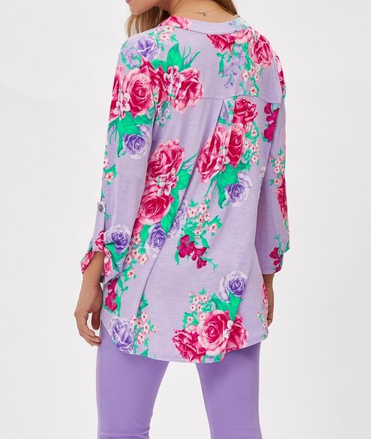 Person wearing a floral long-sleeve top and matching pants on a white background