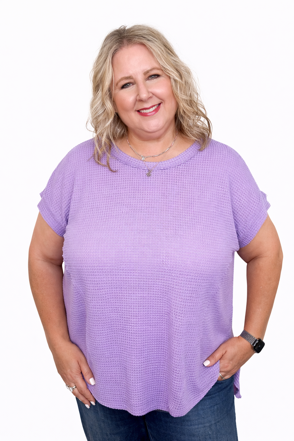 Woman wearing a purple short-sleeve top on a white background