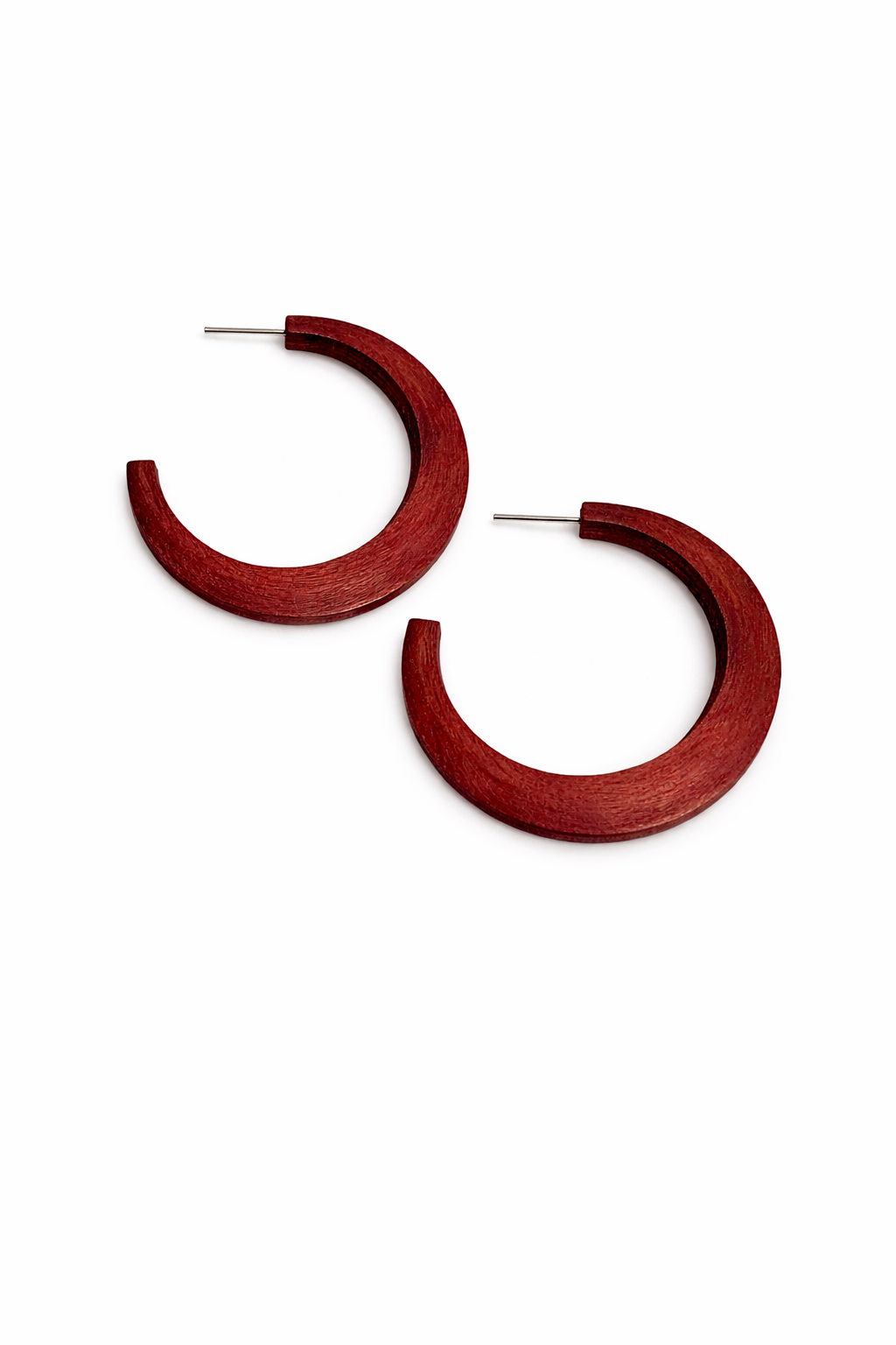 Red hoop earrings on a white background