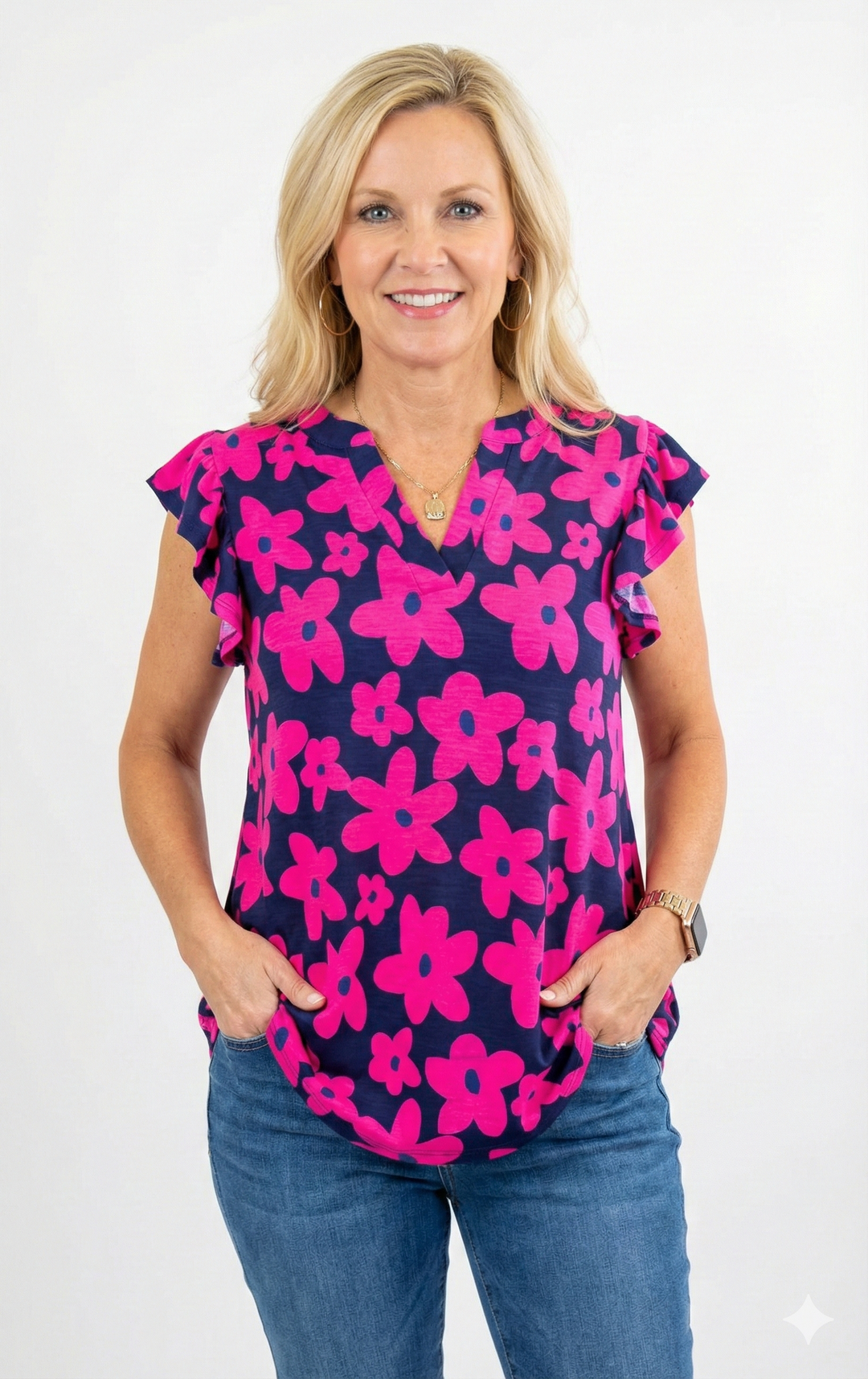 model wearing a pink floral top on a white background
