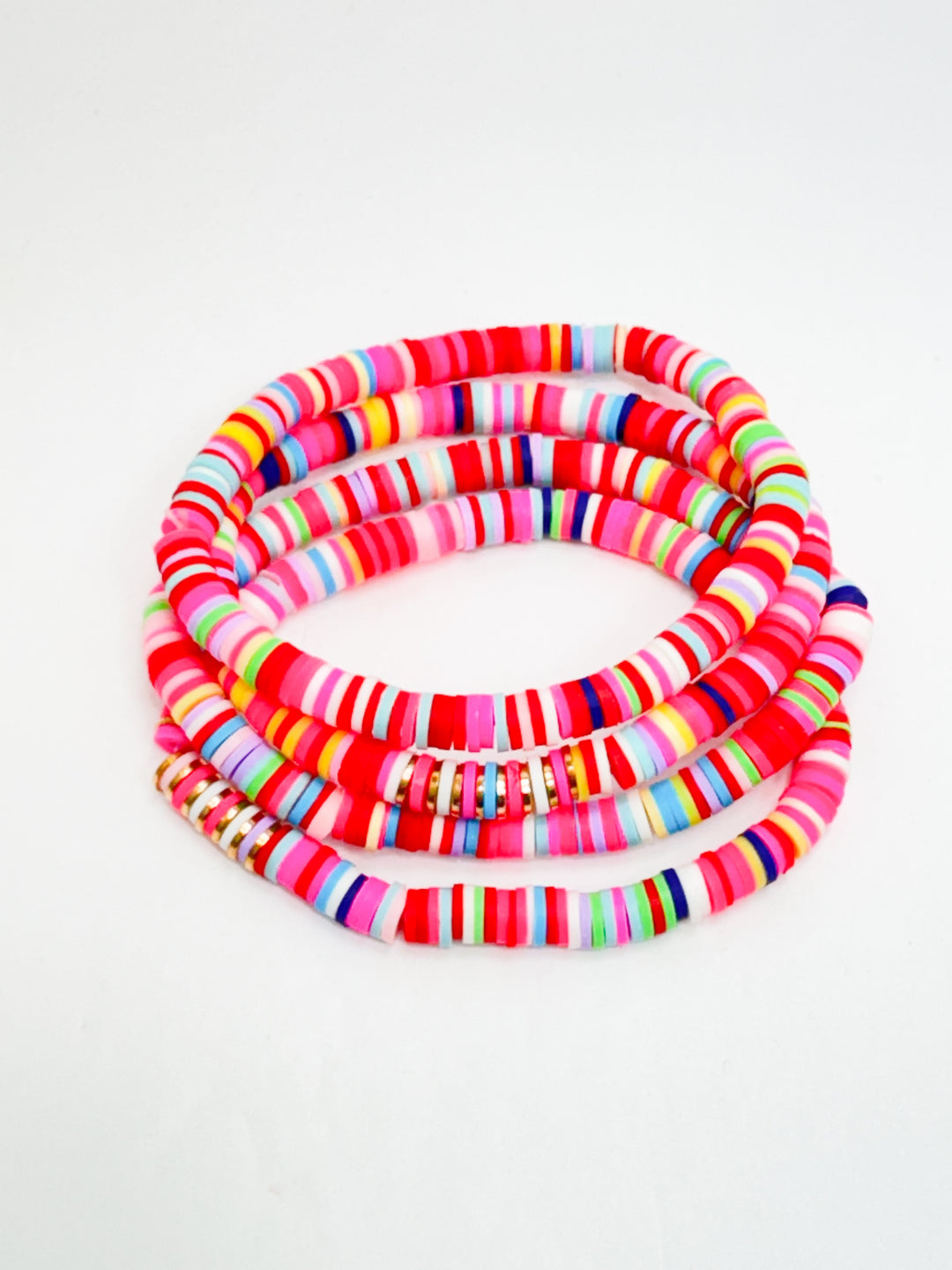 A set of colorful bracelets with a mix of solid and striped patterns.