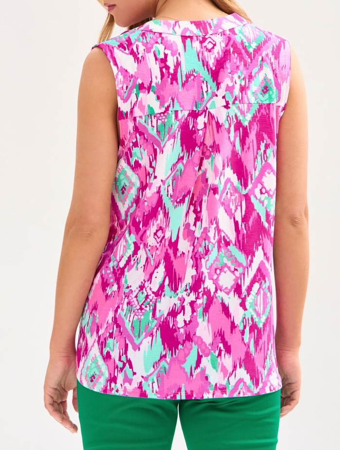 Person wearing a sleeveless top with a colorful abstract pattern on a white background