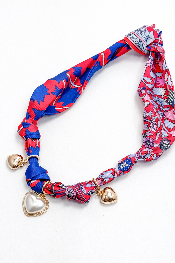 Colorful headband with heart-shaped charms on a white background