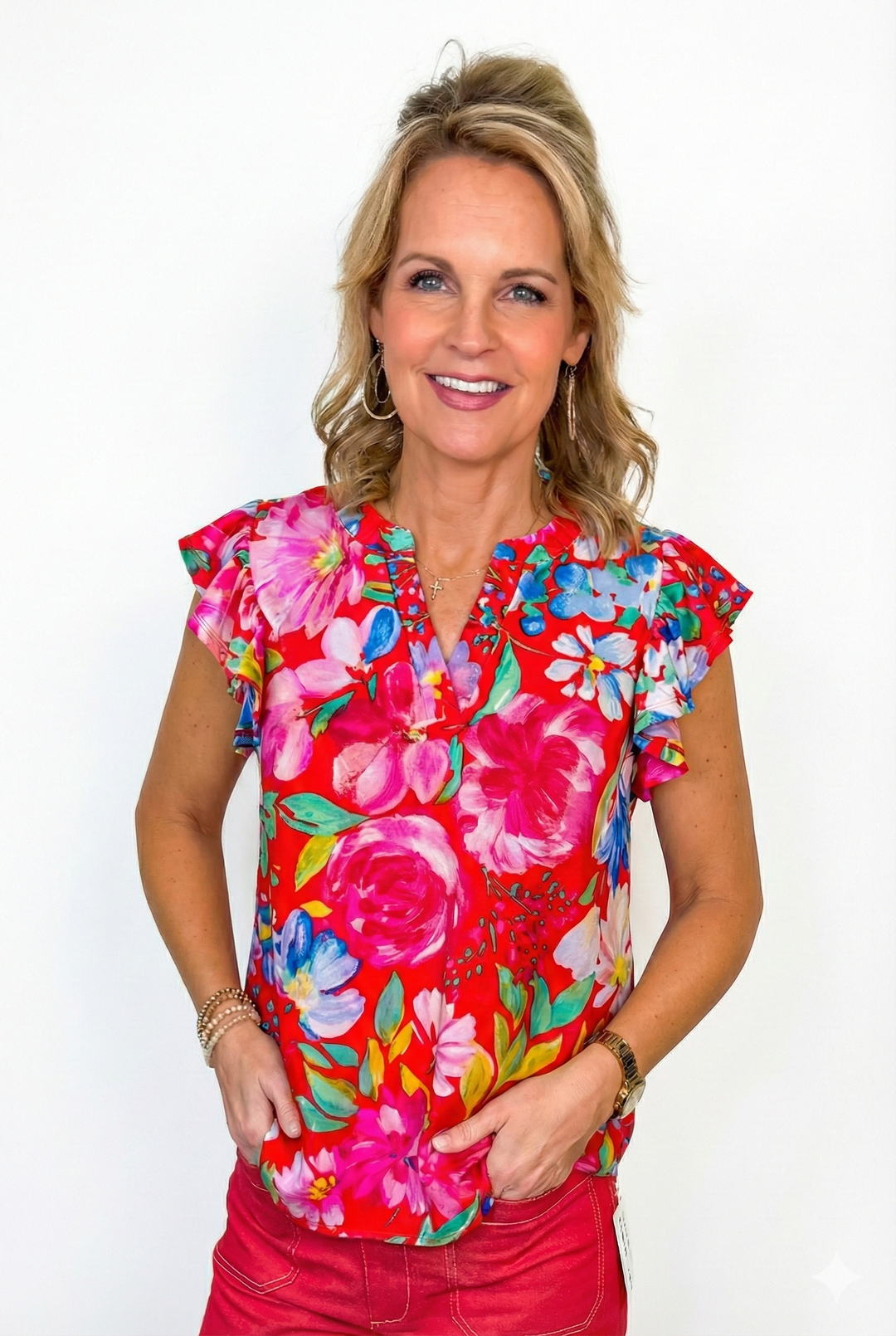 Woman wearing a colorful floral blouse with a white background