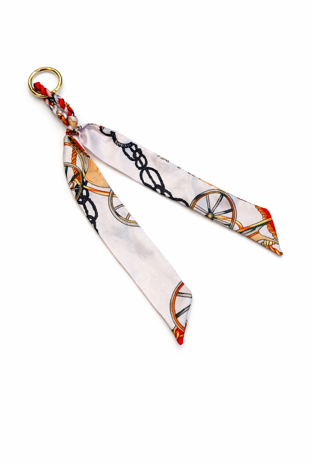 Decorative keychain with a patterned ribbon on a white background