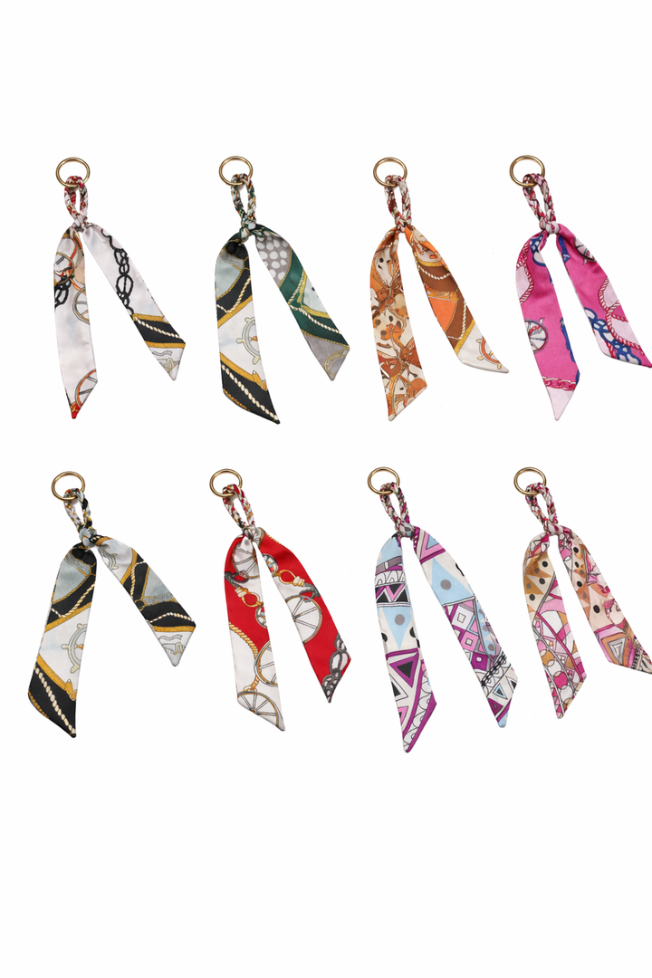 Set of colorful fabric keychains on a white background