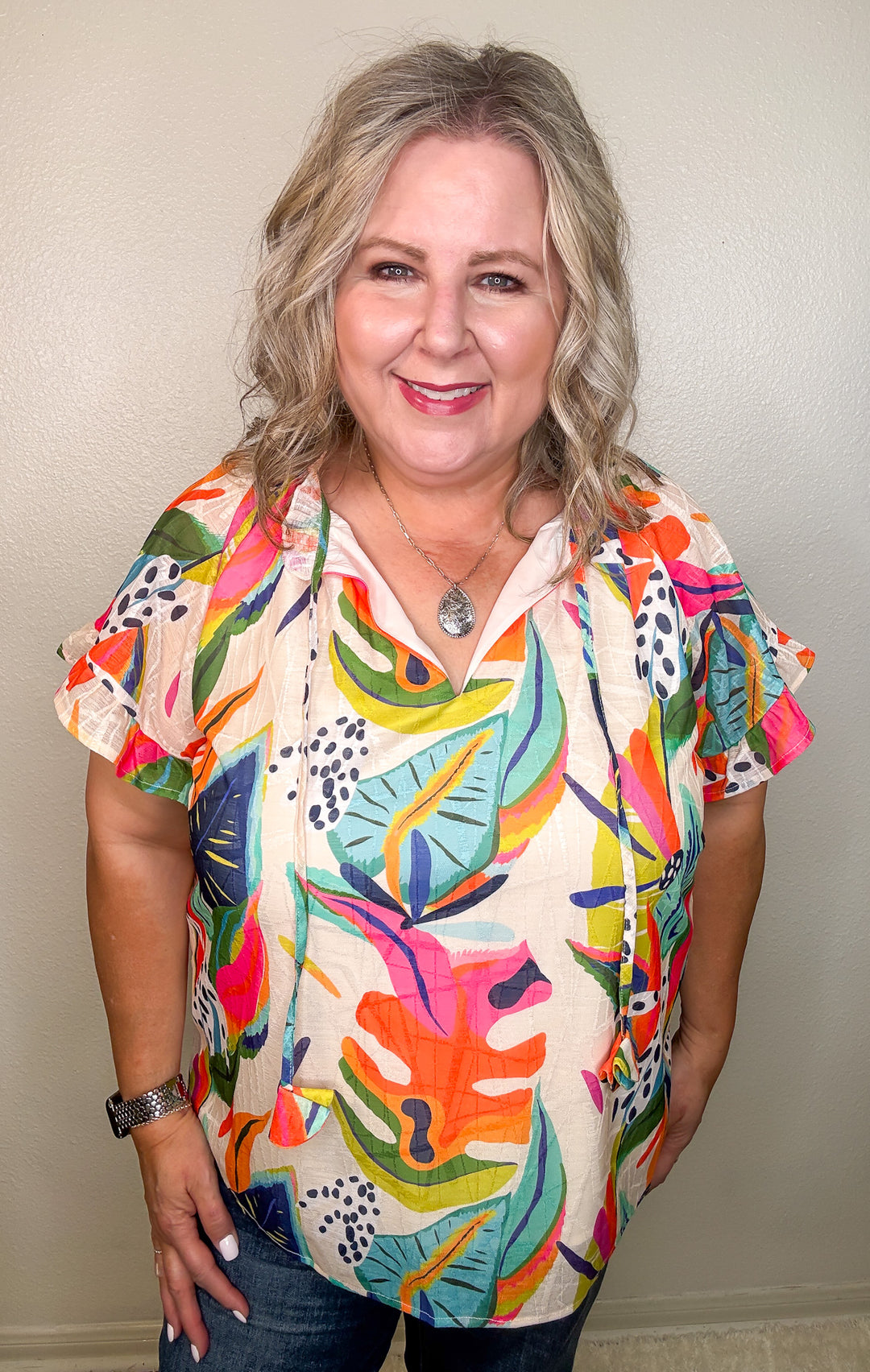 model wearing a tropical floral top