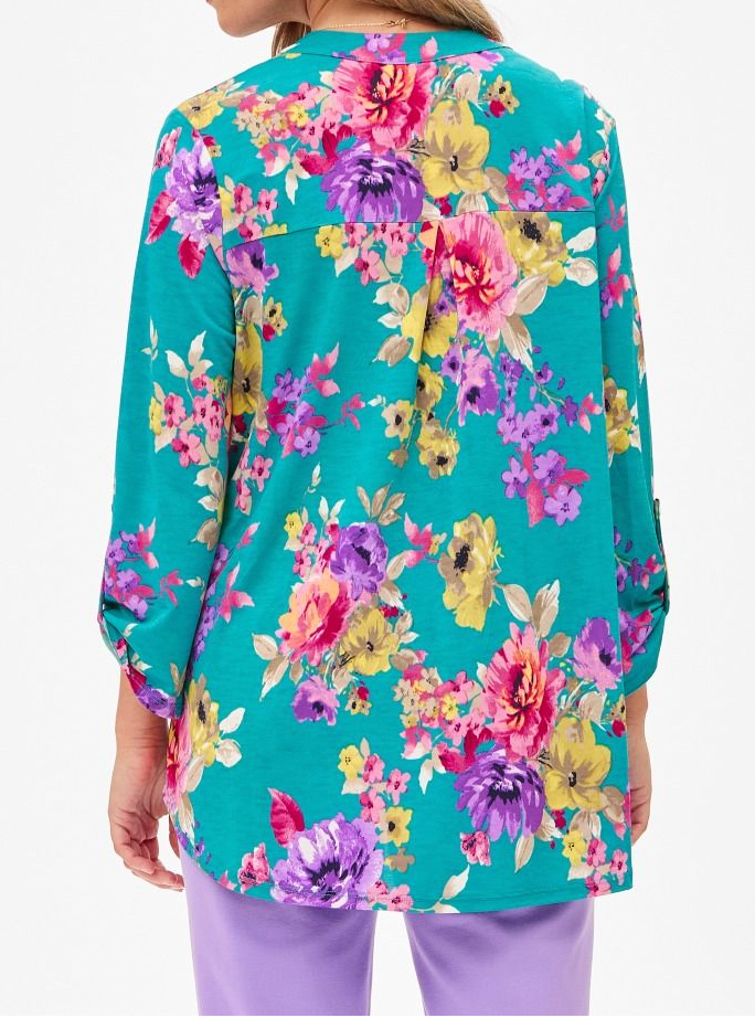 Person wearing a colorful floral shirt with a white background